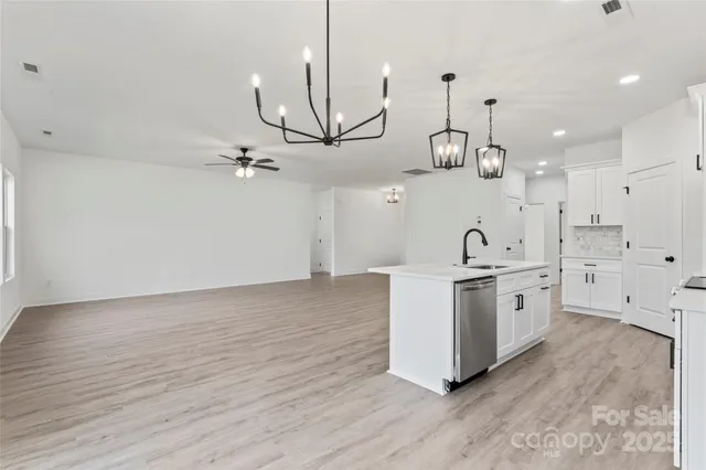 a view of a livingroom with a ceiling fan and window