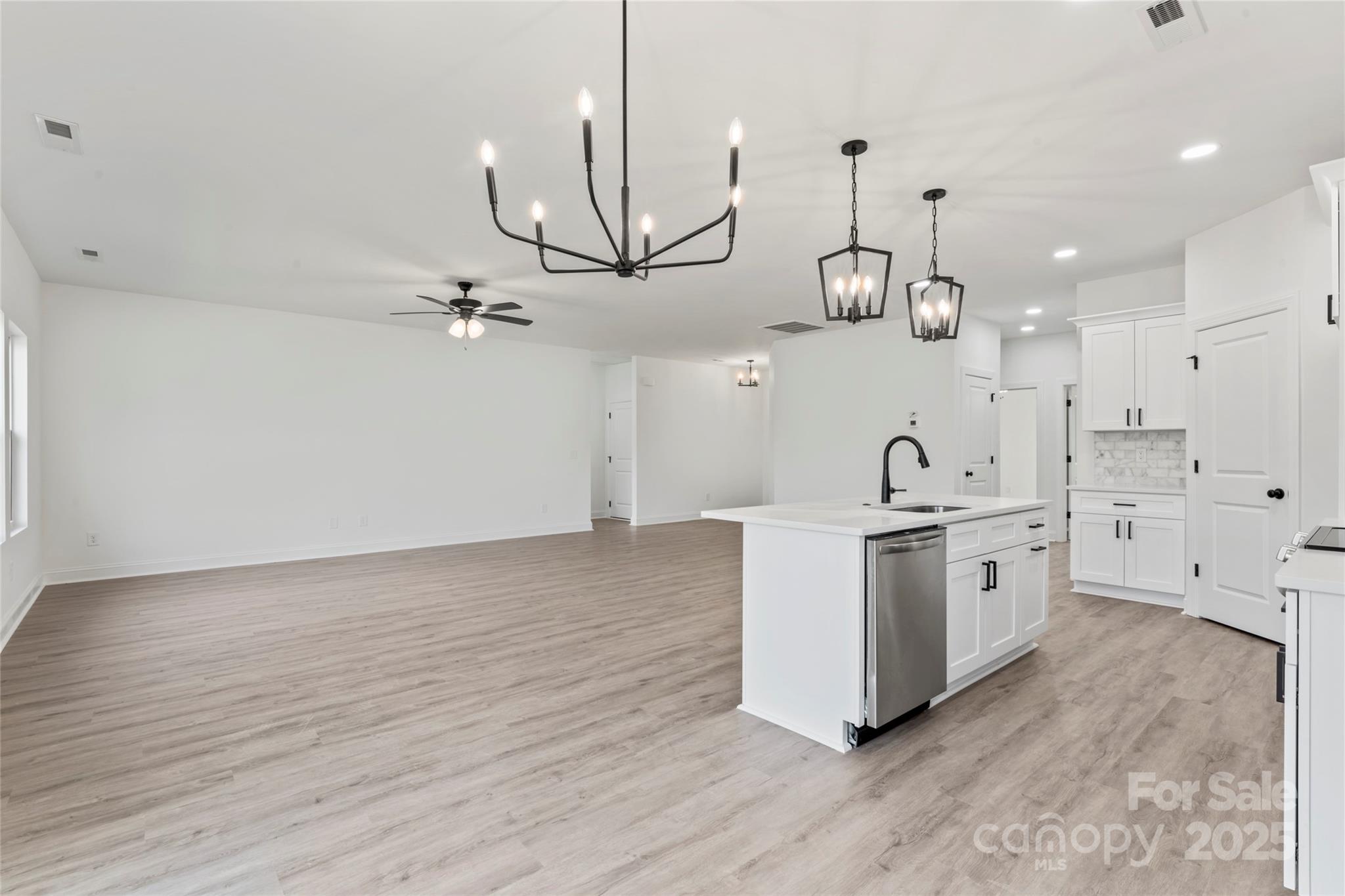 1 Morehead Road Harrisburg, NC 28075 - Photo 14 of 32 a kitchen with white cabinets and stove