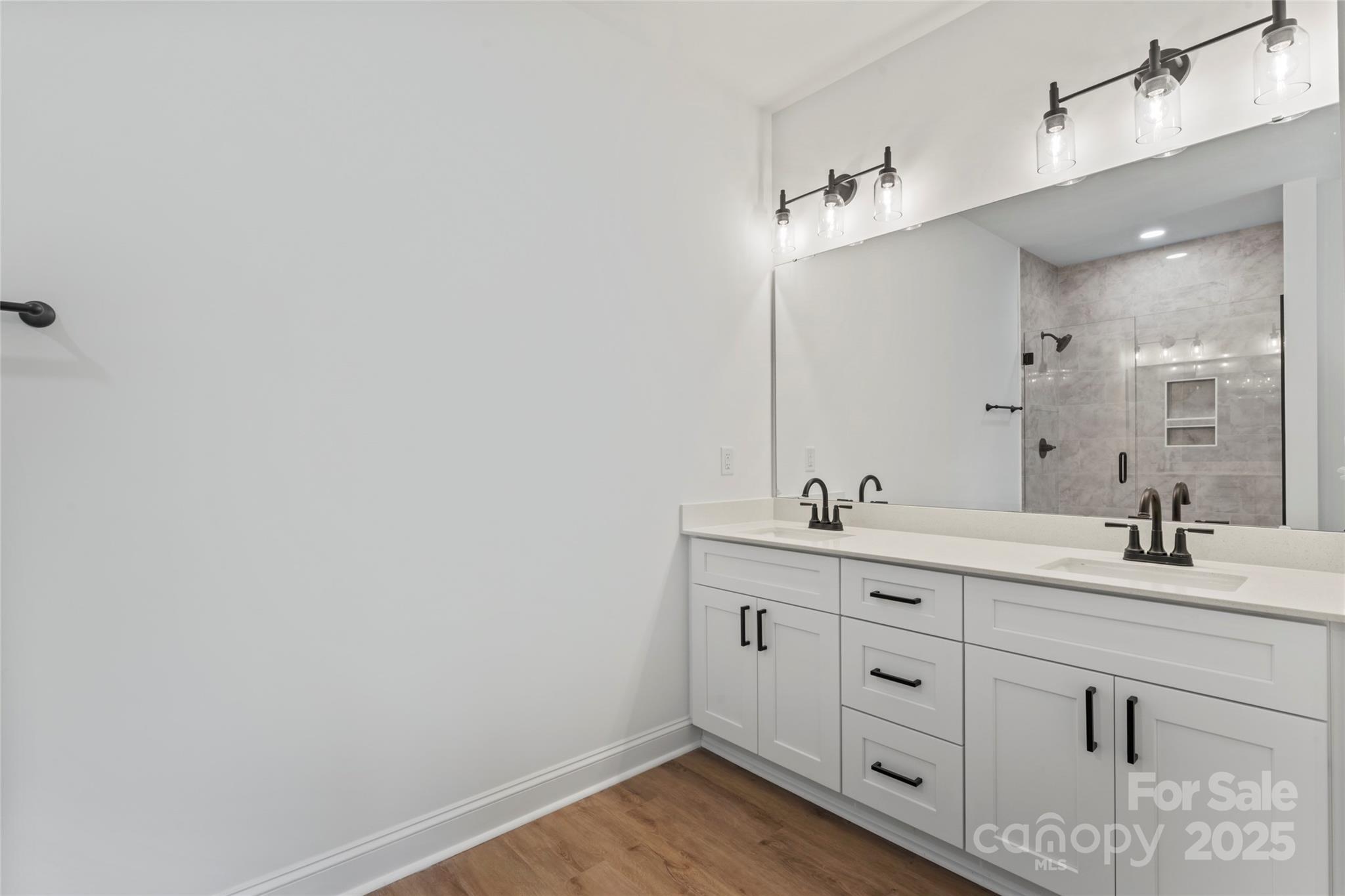 1 Morehead Road Harrisburg, NC 28075 - Photo 19 of 32 a bathroom with a double vanity sink and mirror