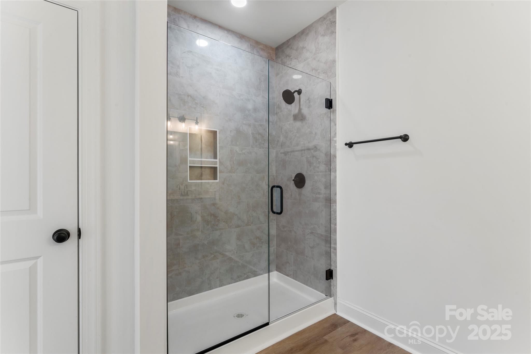 1 Morehead Road Harrisburg, NC 28075 - Photo 20 of 32 a bathroom with a glass shower door