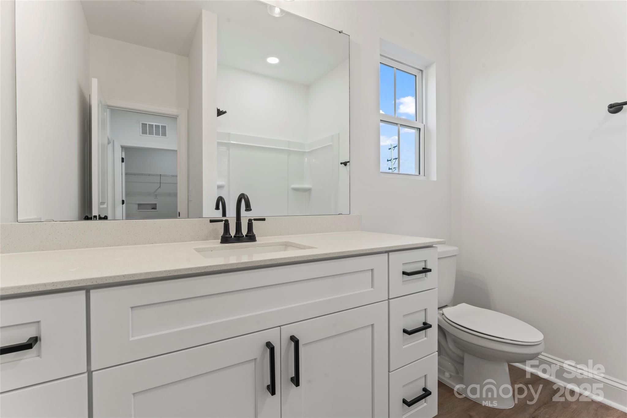 1 Morehead Road Harrisburg, NC 28075 - Photo 28 of 32 a bathroom with a sink a toilet and a mirror