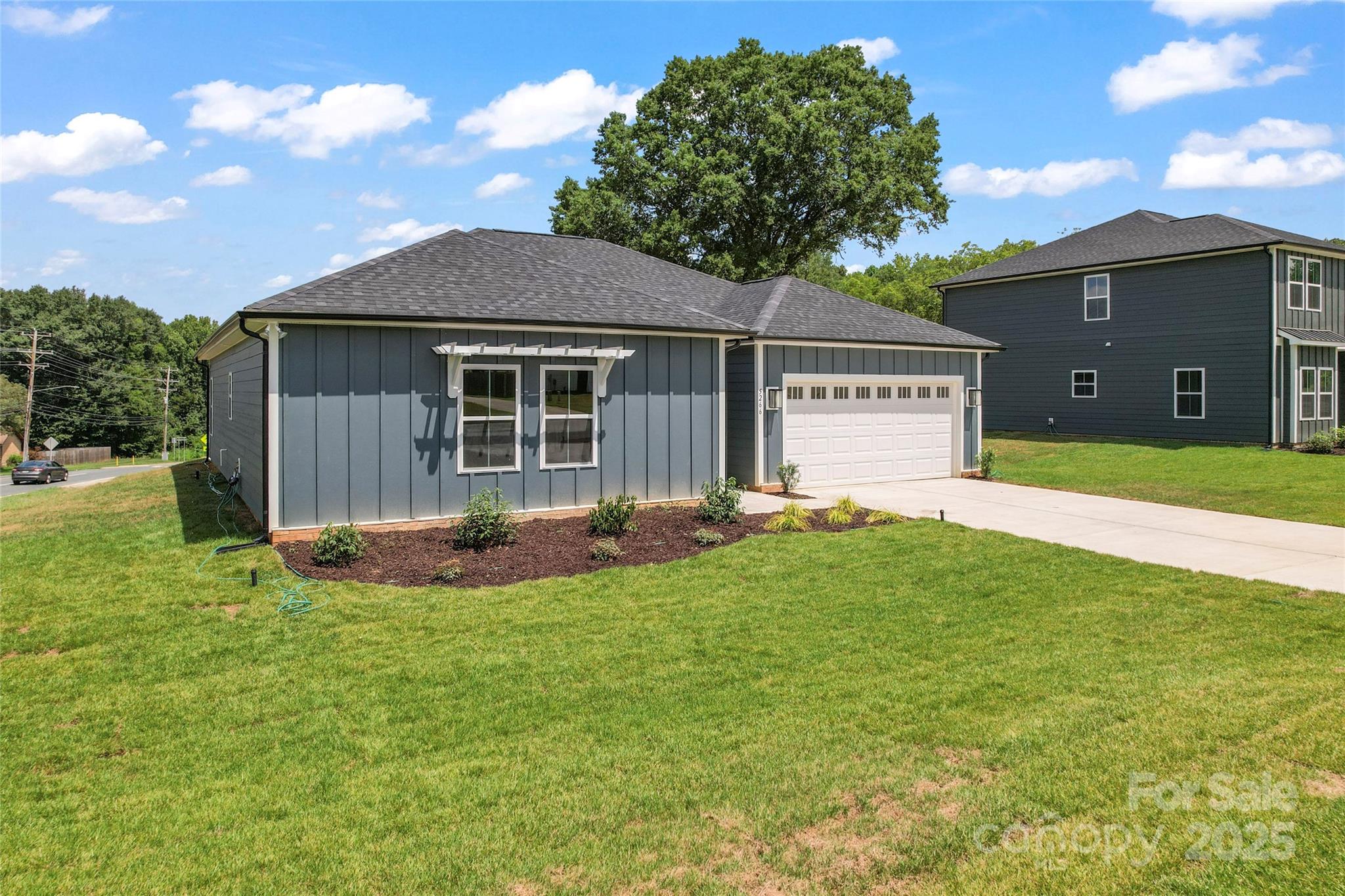 1 Morehead Road Harrisburg, NC 28075 - Photo 30 of 32 a view of a house with a yard and a large tree