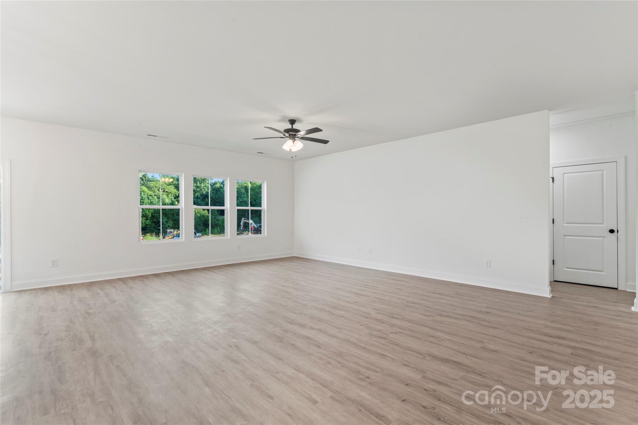 1 Morehead Road Harrisburg, NC 28075 - Photo 8 of 32 a view of an empty room with wooden floor and a window