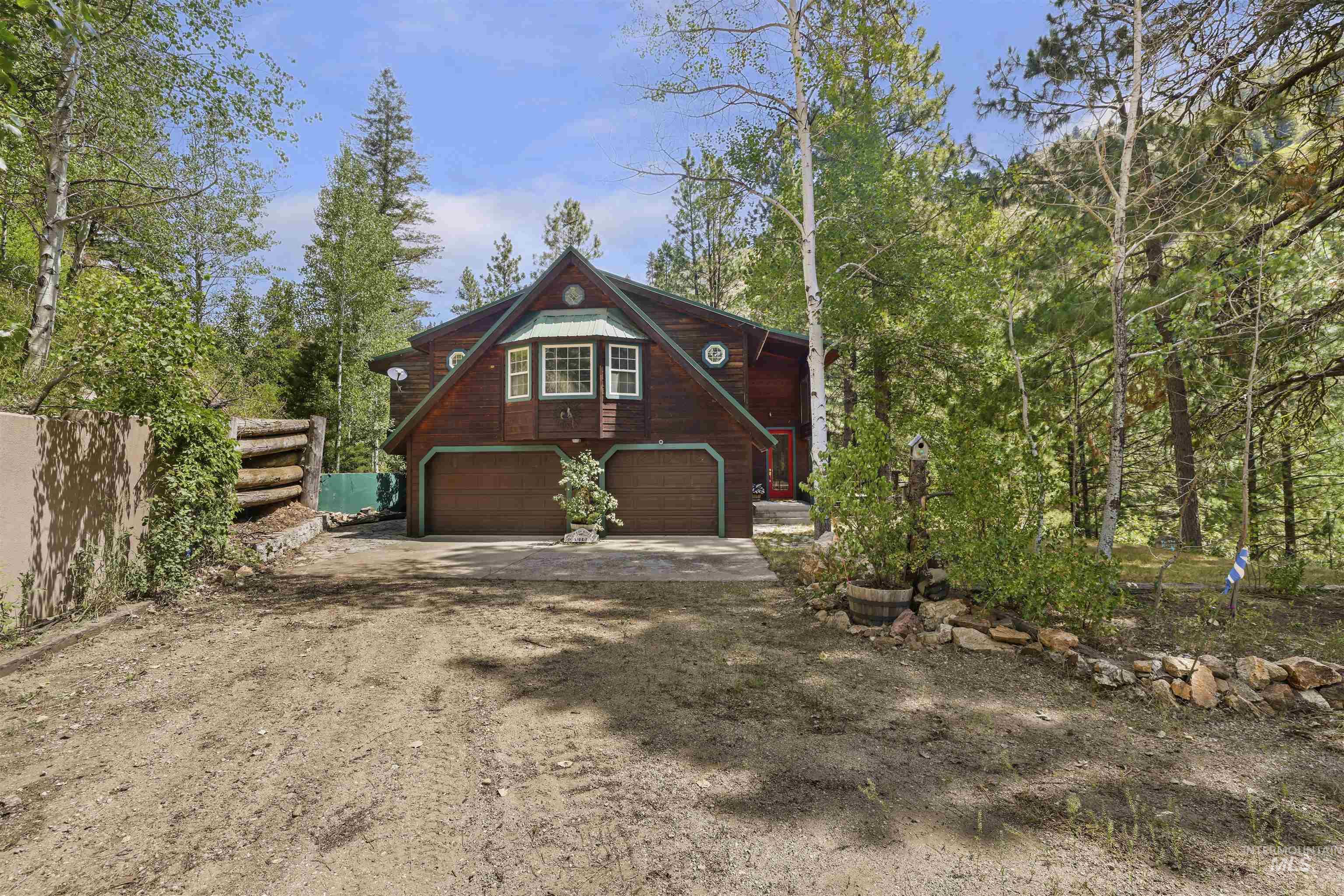 224 Dakota Road Mountain Home, ID 83647 - Photo 41 of 50 Rustic-style residence featuring a prominent gable roof, two-car garage, and upper-level dormer window