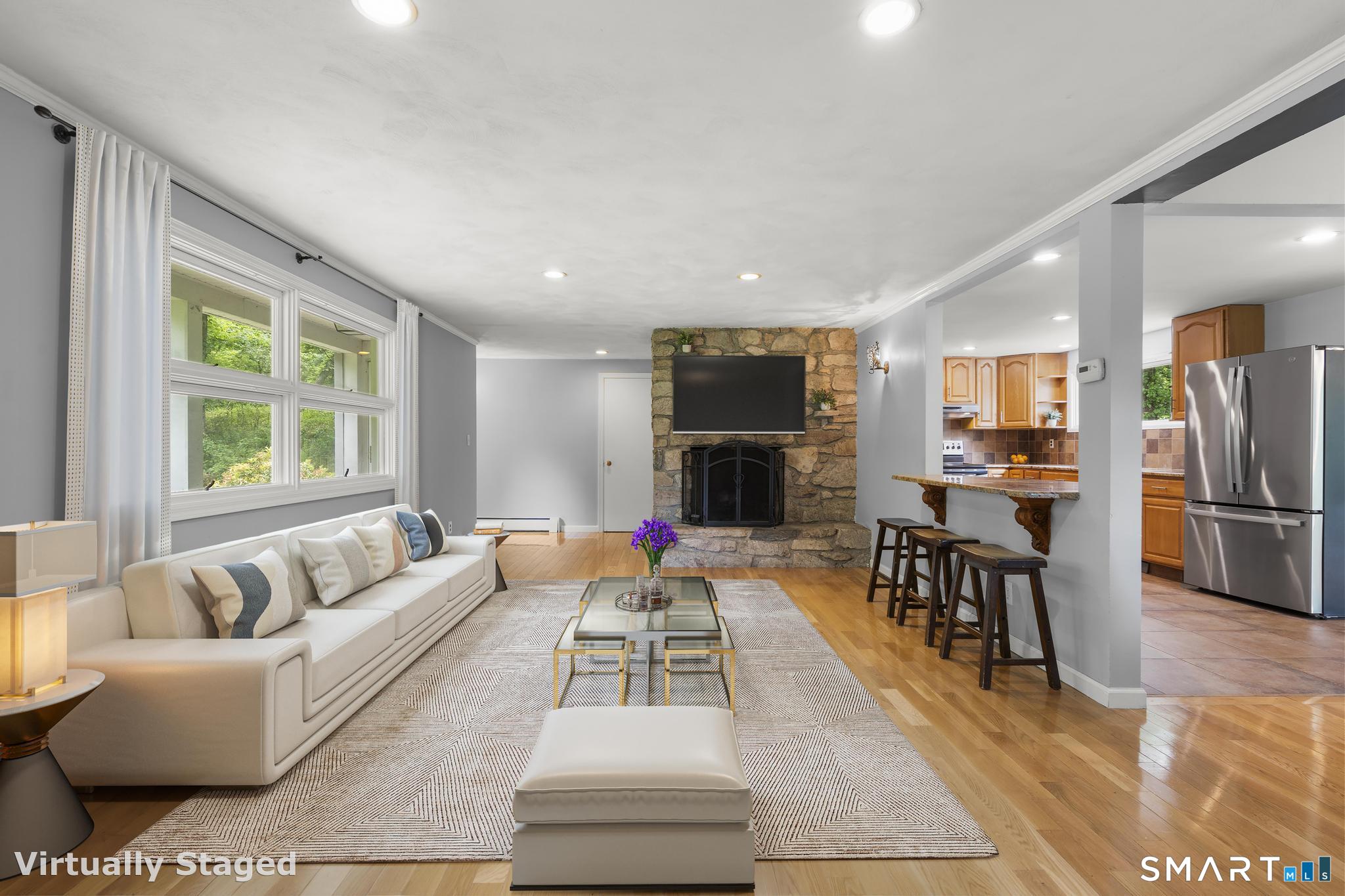 200 Old Huckleberry Road Wilton, CT 06897 - Photo 2 of 24 a living room with furniture and a fireplace
