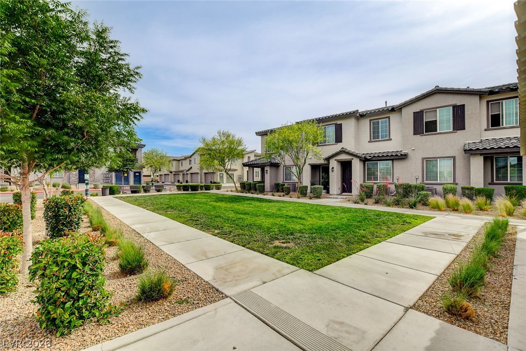 7330 North Decatur Boulevard, Unit 6 North Las Vegas, NV 89084 - Photo 22 of 42 A community of well-maintained homes features inviting green spaces and pathways.