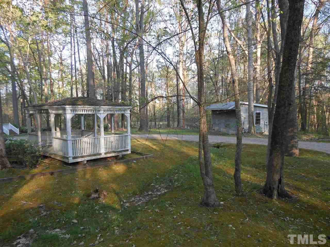 800 Mudham Road Wendell, NC 27591 - Photo 15 of 25 Gazebo, horse barn and pond beyond the house.