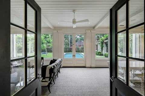 a room with furniture and large windows