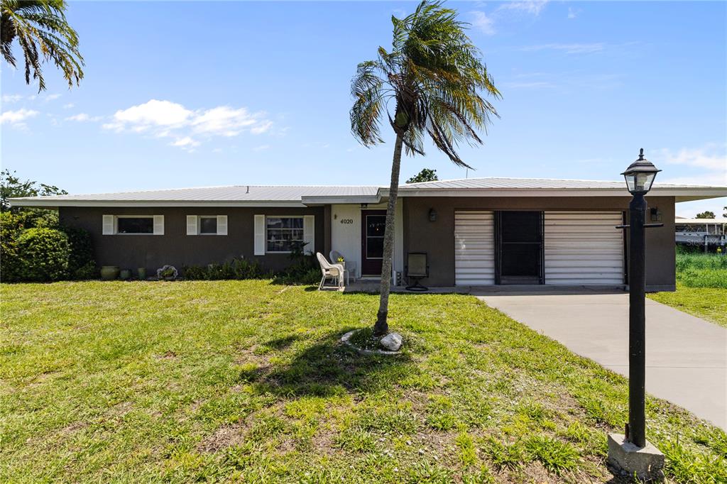 4020 Palm Drive Punta Gorda, FL 33950 - Photo 1 of 24 a house view with a garden space