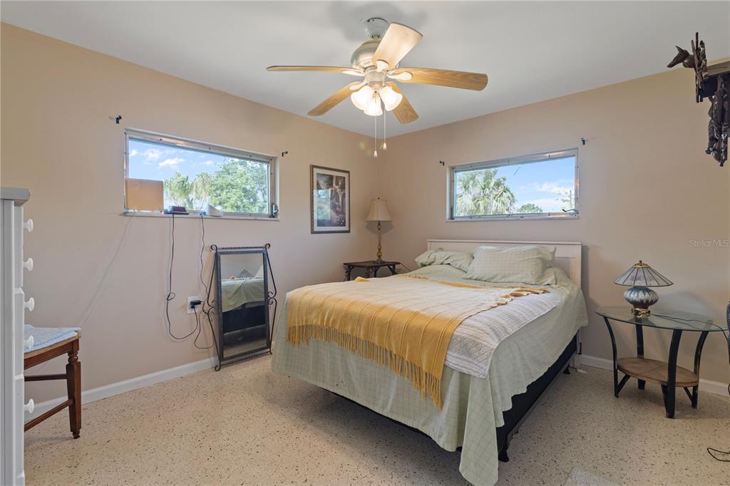 4020 Palm Drive Punta Gorda, FL 33950 - Photo 14 of 24 a bedroom with a bed and a chandelier
