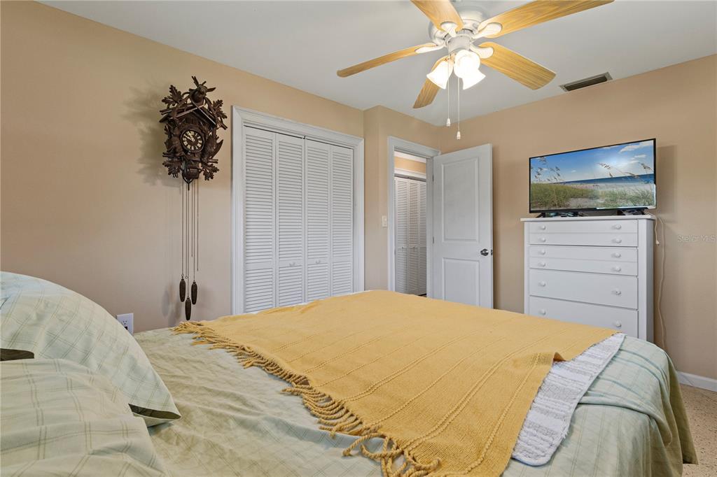 4020 Palm Drive Punta Gorda, FL 33950 - Photo 15 of 24 a bedroom with a bed and a chandelier