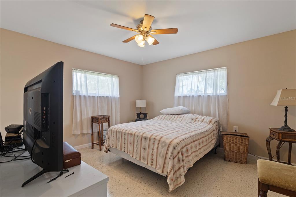 4020 Palm Drive Punta Gorda, FL 33950 - Photo 16 of 24 a bedroom with a bed and a chandelier