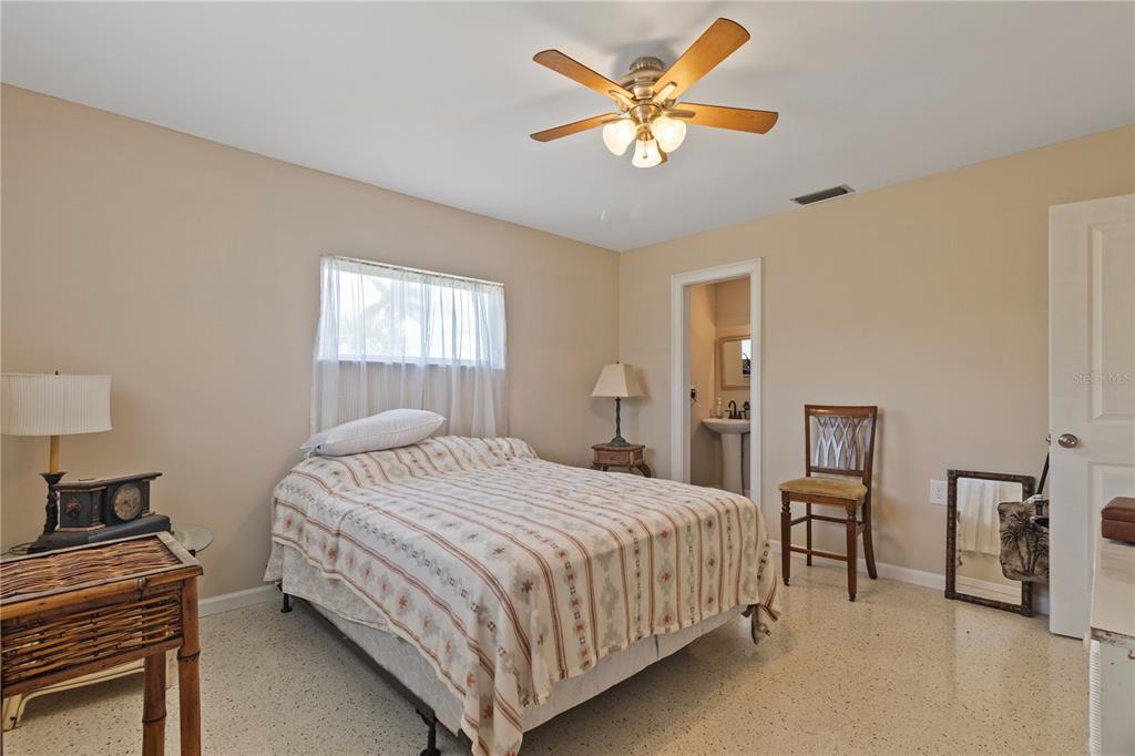 4020 Palm Drive Punta Gorda, FL 33950 - Photo 17 of 24 a bedroom with a bed and a chandelier