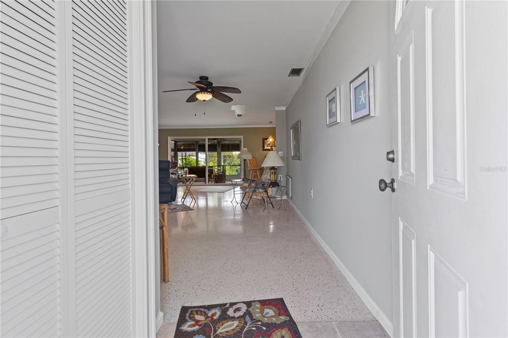 4020 Palm Drive Punta Gorda, FL 33950 - Photo 3 of 24 a view of a hallway with a dining table and chairs