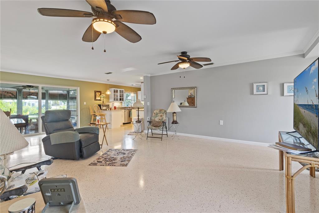 4020 Palm Drive Punta Gorda, FL 33950 - Photo 7 of 24 a living room with furniture a ceiling fan and a flat screen tv