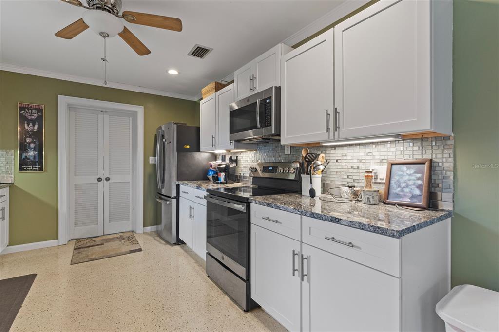 4020 Palm Drive Punta Gorda, FL 33950 - Photo 10 of 24 a kitchen with stainless steel appliances granite countertop a refrigerator sink and stove