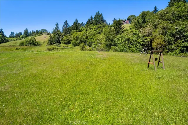 a backyard of a house with a yard and outdoor seating