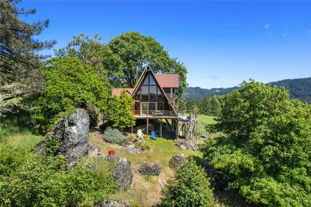 a view of a lush green hillside and a houses