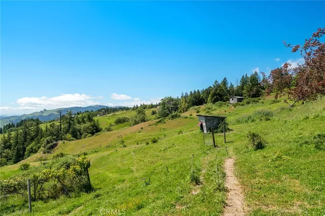 a view of balcony with chairs and wooden fence