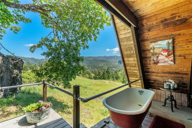 a view of a room with a large window and table or chairs