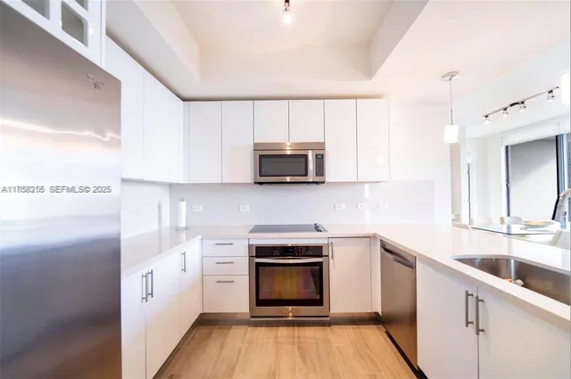 a kitchen with a sink stove and microwave