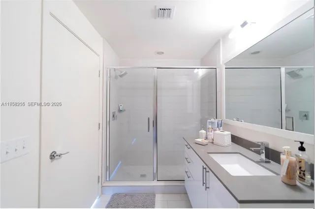 a bathroom with a double vanity sink and mirror