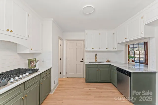 a kitchen with a sink stove and cabinets