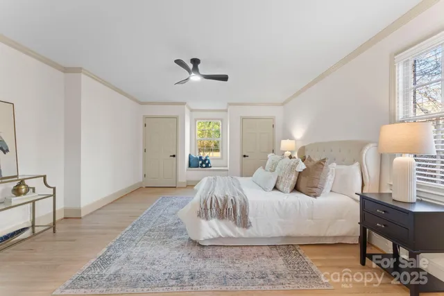 a spacious bedroom with a bed and a table