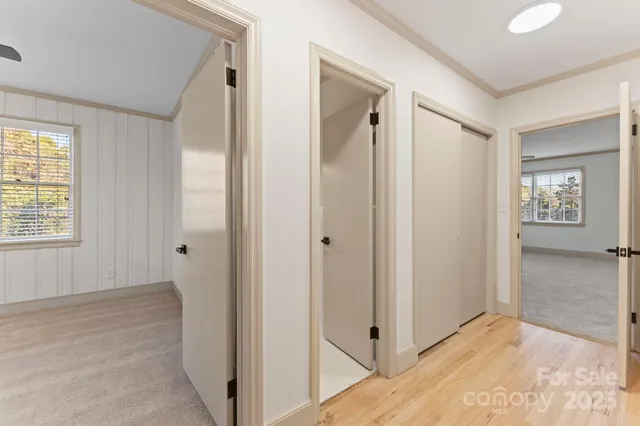 an empty room with a window and a ceiling fan