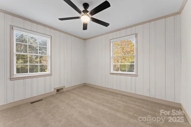 a view of an empty room and a ceiling fan