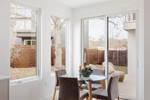 a bedroom with a bed a mirror and a window