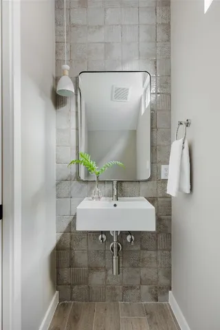 a bedroom with a bed a mirror and a window