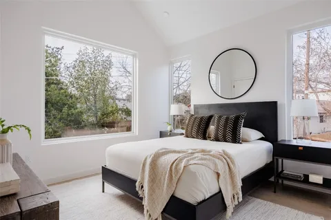 a bedroom with a bed and a mirror