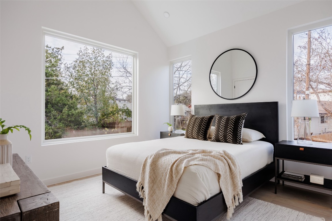 3209 Dolphin Drive, Unit 2 Austin, TX 78704 - Photo 18 of 40 a bedroom with a bed a mirror and a window