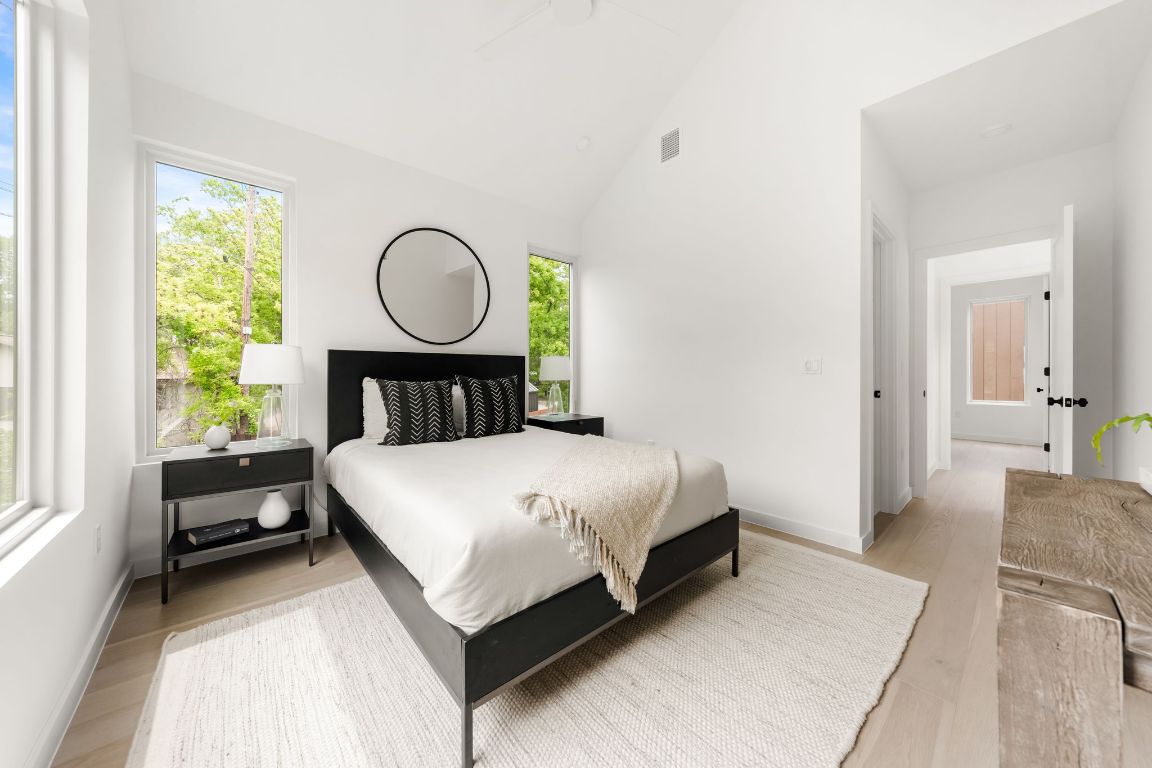 3209 Dolphin Drive, Unit 2 Austin, TX 78704 - Photo 19 of 40 a bedroom with a bed a mirror and a window