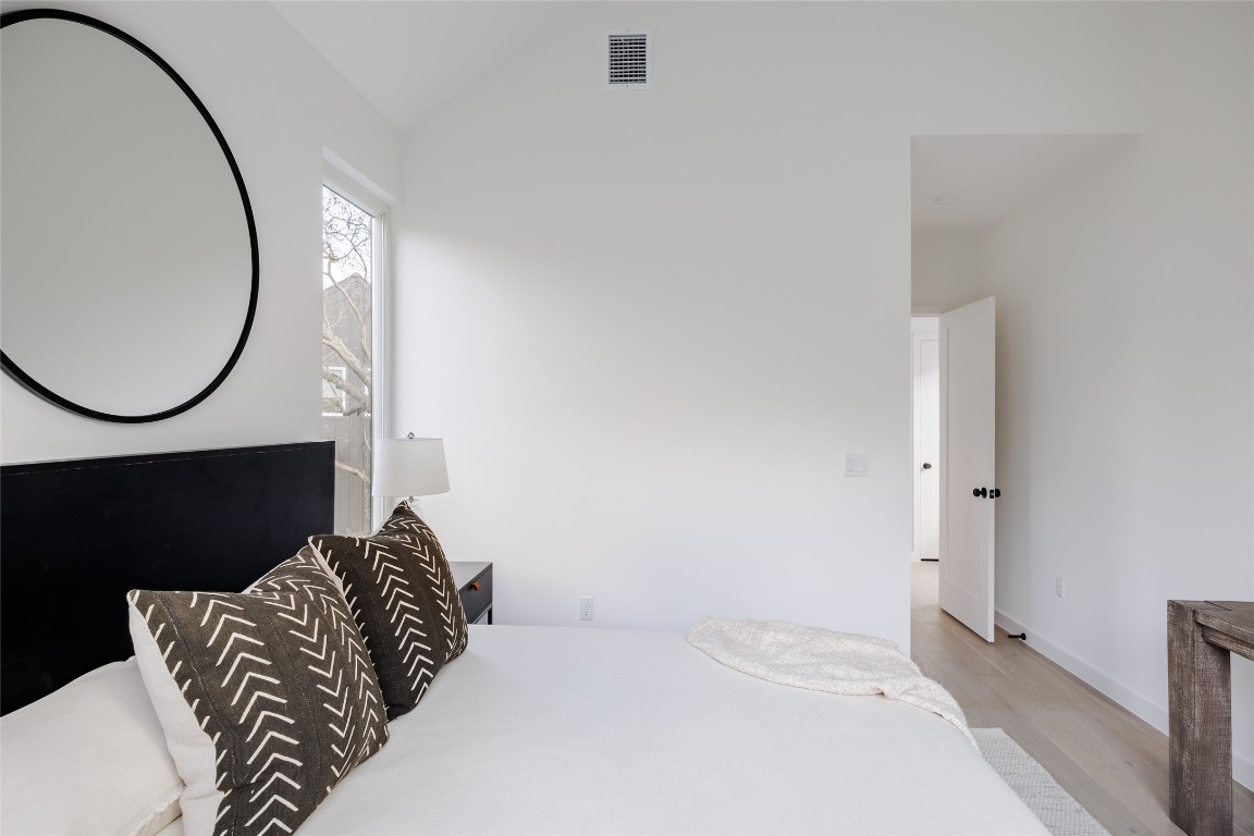 3209 Dolphin Drive, Unit 2 Austin, TX 78704 - Photo 20 of 40 a bedroom with a bed and a mirror