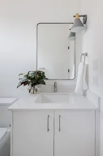 a bathroom with a shower a toilet and sink