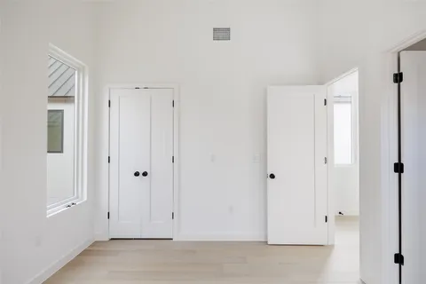 a bathroom with a granite countertop sink a toilet and a mirror