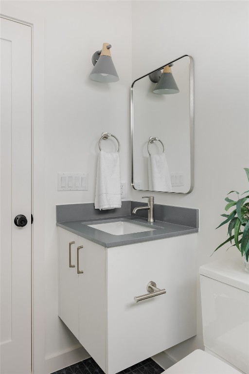 3209 Dolphin Drive, Unit 2 Austin, TX 78704 - Photo 27 of 40 a bathroom with a granite countertop sink a toilet and a mirror
