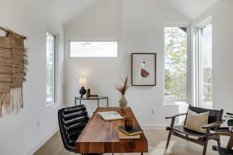 a view of a workspace with furniture and a window