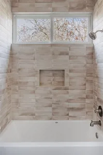 a picture of a bathroom with a shower