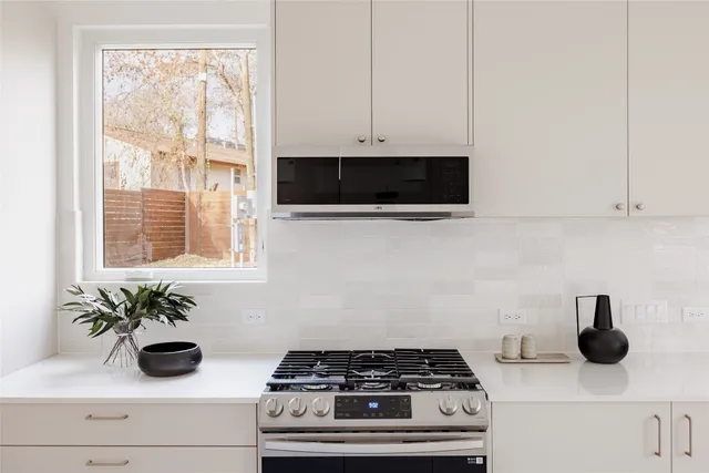 a kitchen with a stove and a window