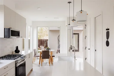 a kitchen with stainless steel appliances kitchen island granite countertop a stove and a refrigerator