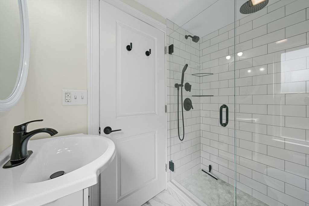 400 Adams Street, Unit A Milton, MA 02186 - Photo 11 of 27 a bathroom with a sink and shower
