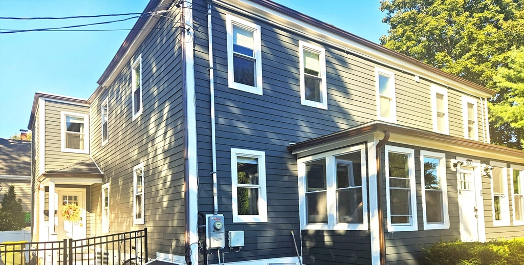 400 Adams Street, Unit A Milton, MA 02186 - Photo 21 of 27 a view of a brick building next to a yard