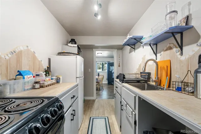 a view of a yard with wooden fence and a large tree