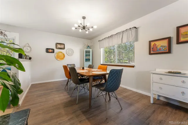 a dining room with furniture a window and wooden floor