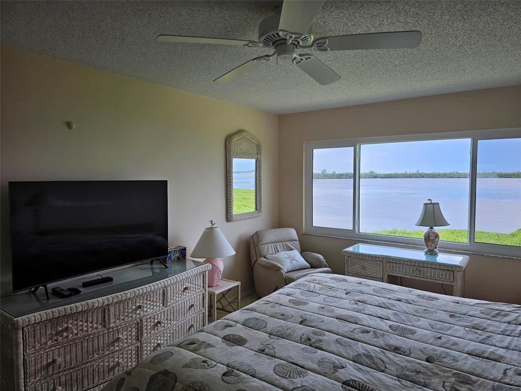 4765 Independence Drive Bradenton, FL 34210 - Photo 15 of 39 a bedroom with furniture and a flat screen tv