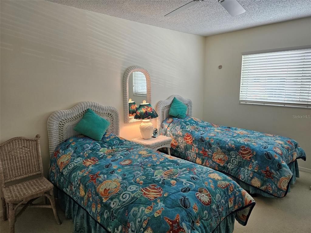 4765 Independence Drive Bradenton, FL 34210 - Photo 19 of 39 a bedroom with two beds and a window