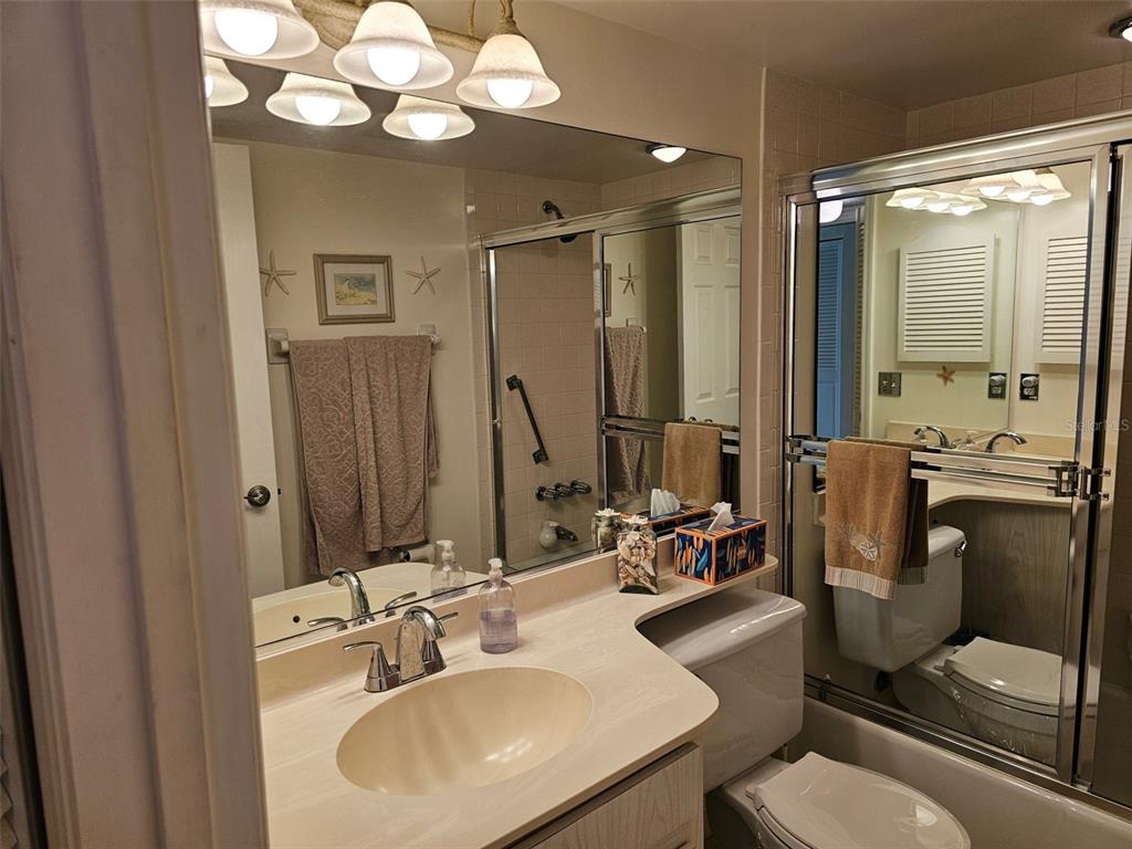 4765 Independence Drive Bradenton, FL 34210 - Photo 23 of 39 a bathroom with a sink mirror and toilet